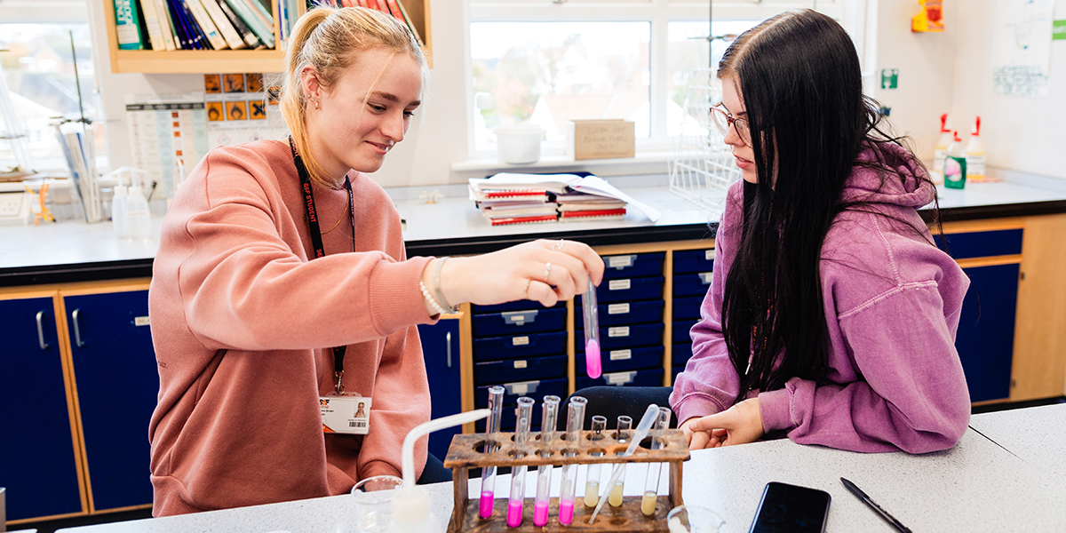 Students in a science lab looking at test tubes
